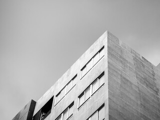 The top corner of a modern concrete building.