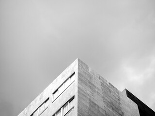 The top corner of a modern concrete building.