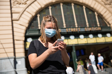 Woman Wearing Face Mask Waiting at Flinders Street Station