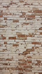 Vertical background of old vintage brick wall with peeling plaster