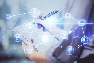 Social network theme hologram over hands taking notes background. Concept of global international people connect. Double exposure