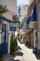 Picturesque alleys in the village of Glossa on the Greek island of Skopelos with white houses and colorful windows and balconies.