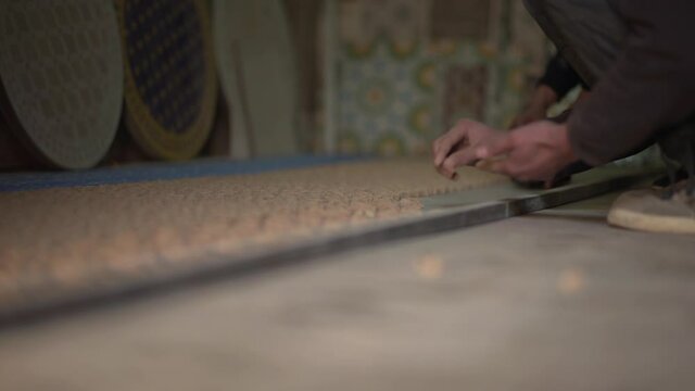 Close up of Moroccan artisan's hands working on Wall Art