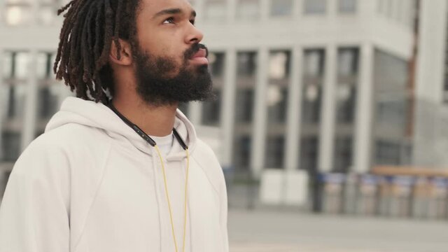 Young Handsome African Man Looking At The Sky Outdoors