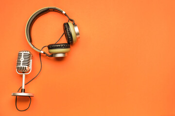 Headphones with microphone on color background - obrazy, fototapety, plakaty