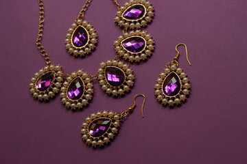 luxury purple jewelry in the Baroque style on a purple background. Vintage, retro style.
copy space
