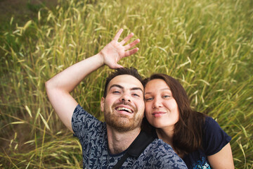 Travel, vacation and holiday concept - Happy caucasian couple taking selfie against background on the wheat field