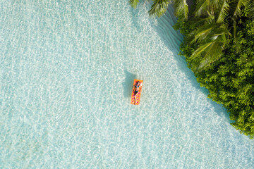 Top above high angle aerial drone view of fit slim attractive girl floating on rubber mattress sea water luxury leisure sunny weather relax enjoying season mild warm pleasant climate wild forest