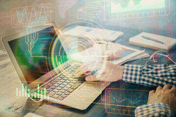 Businessman with computer background with technology theme hologram. Concept of hightech. Multi...