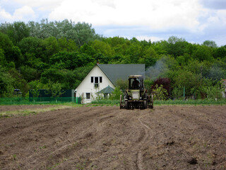Plowed field by tractor in brown soil on open countryside nature