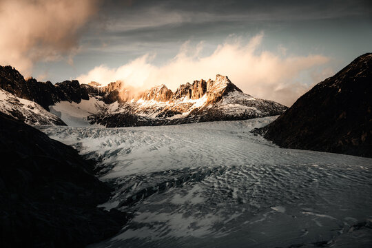 Scenic view of Rohnegletscher glacier valley with mountain in background during sunset
