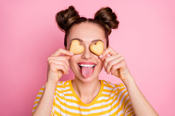 Closeup photo of attractive lady two funny buns flirty hiding eyes by cookies hearts sticking...