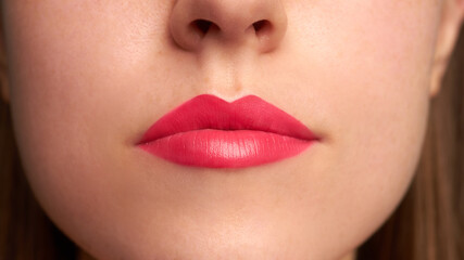 Close-up shot of woman lips with red lipstick. Beautiful perfect lips. Sexy mouth close up.