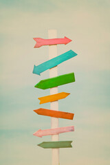 Colorful wooden direction arrow signs