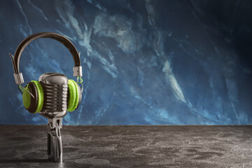 Headphones with microphone on color background