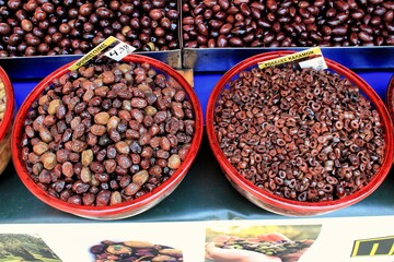 Greece, Athens, July 18 2020 - Stall with Throubes olives and Kalamata or Kalamon olives washers at street market.