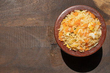 fried rice in a bowl wooden