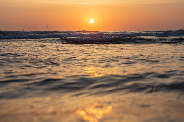 Fototapeta na wymiar The sun rises over the mediterranean sea on a clear sky morning