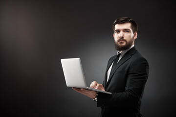 Sales person holding open laptop in hands