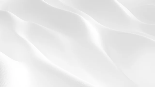 Closeup wavy white satin fabric background. White smooth silk