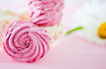 Apple and raspberry zephyr on pink background.  Sweet food.