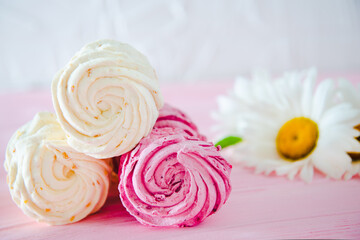 Apple and raspberry zephyr on pink background.  Sweet food.