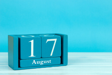 wooden calendar with the date of August 17 on a blue wooden background, International Black Cat Day