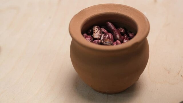 Dried Red beans in a faience pot. 4k video shot.