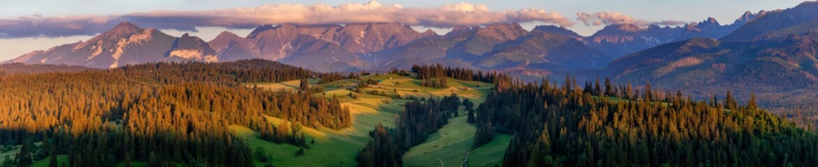  wide panorama of the Tatra Mountains in Poland in warm colors of the setting sun