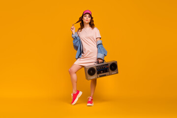 Full length body size view of nice attractive flirty cheerful girlish funny foxy ginger girl carrying boombox sending air kiss having fun isolated on bright vivid shine vibrant yellow color background