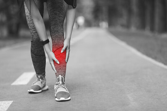 Shin Splints Injury. Female Athlete Massaging Injured Leg, Suffering Trauma During Jogging