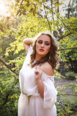 Naklejka premium Beautiful mystery gothic woman in long white dress in autumn forest.