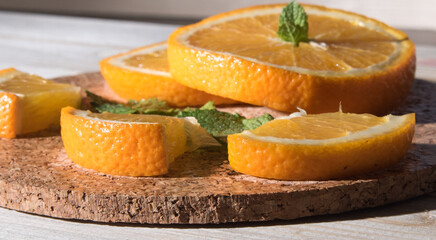 Fototapeta na wymiar Orange slices, whole, on a wooden table