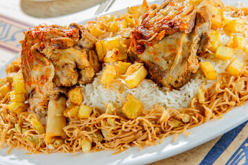 Plate of rice with baked mutton leg.