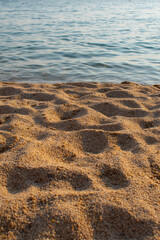 Close up of sandy beach with turquoise water.  Copy space. Warm and cold tones