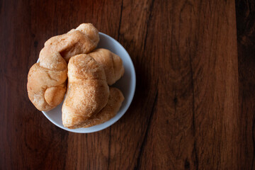 Small croissants on wooden background. Wallpaper, copy space, home-made.