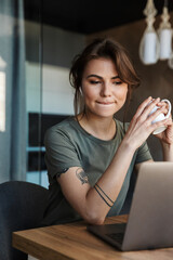 Attractive young woman working on laptop computer