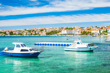 Fototapeta na wymiar Croatia, town of Novalja on the island of Pag, boats in marina and turquoise sea with boats in foreground