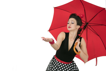 Retro woman in polka dot dress with red umbrella