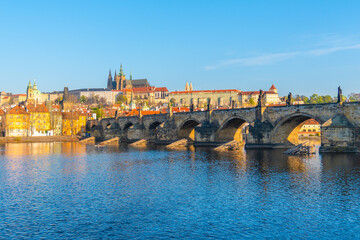 Panoramic view of Prague Castle and Charles Bridge on sunny spring morning, Praha, Czech Republic