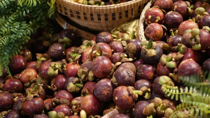 Fruits and vegetables on rustic stall. Assorted fresh ripe fruits and vegetables placed on rustic oriental stall in market. sweet tropical purple mangosteen. Queen of fruits in Thailand