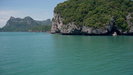 Fototapeta na wymiar Group of Islands in ocean at Ang Thong National Marine Park near touristic Samui paradise tropical resort. Archipelago in the Gulf of Thailand. Idyllic turquoise sea natural background with copy space