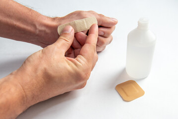 disinfecting the wound on the hand and applying a patch