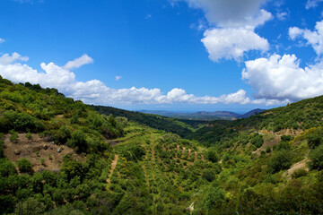 Obraz premium Panoramic view of the island of Crete in Greece. Landscape with views of green fields, settlement and blue sky with clouds. Colour photo. Colour photo