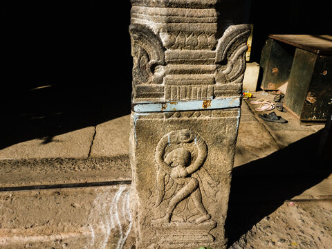 A carving of a figurine on a stone pillar of an ancient temple in Trichy