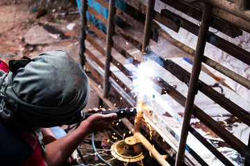 welder connects metal parts to complex structures using electric welding.Selective Focus