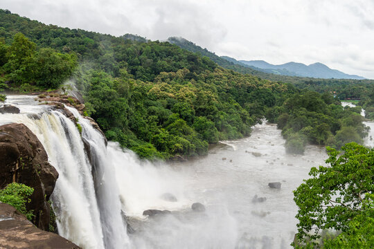 Beautiful nature view during Mansoon time with full filled water fall and green forest from the famous tourist place in Kerala, India called Athirappalli, Vaazhachaal