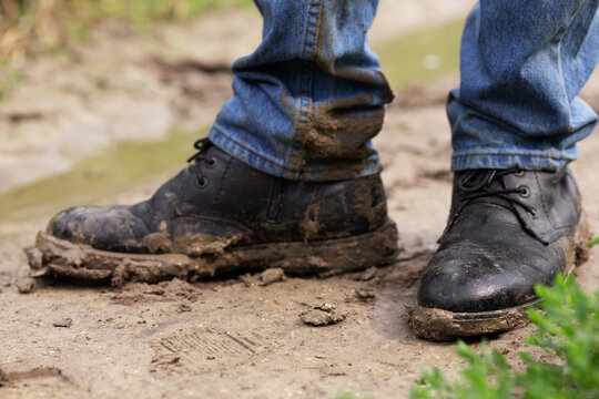 Men's shoes in the mud and swamp. Countryside