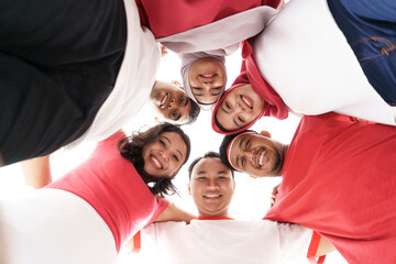 friend making circle embrace and hold each other together wearing red and white shirt color of...