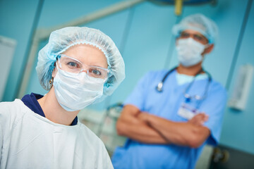 Portrait of surgeons team in hospital. Colored male and caucasian female doctors